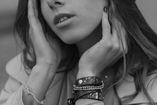 A person sitting calmly in a well-lit room, suggesting a state of focus.